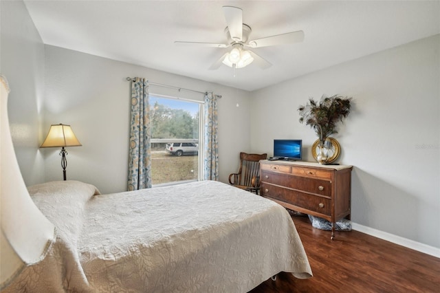 bedroom with dark wood-style floors, baseboards, and a ceiling fan