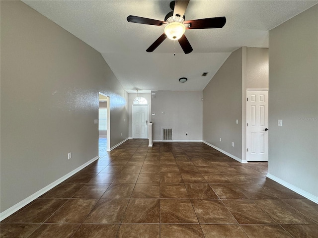 unfurnished living room with lofted ceiling, baseboards, visible vents, and a textured ceiling