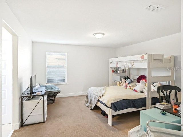 carpeted bedroom featuring visible vents and baseboards