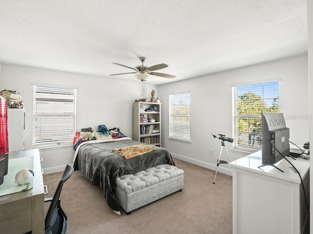 bedroom featuring carpet floors, a textured ceiling, baseboards, and a ceiling fan