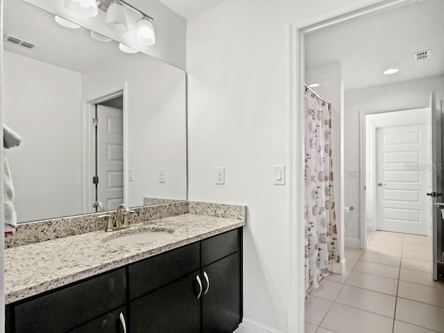 full bathroom with baseboards, vanity, visible vents, and tile patterned floors