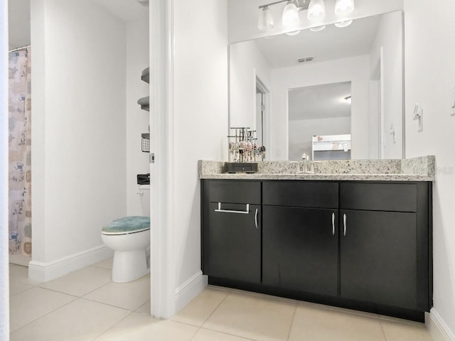 bathroom with baseboards, visible vents, toilet, tile patterned floors, and vanity