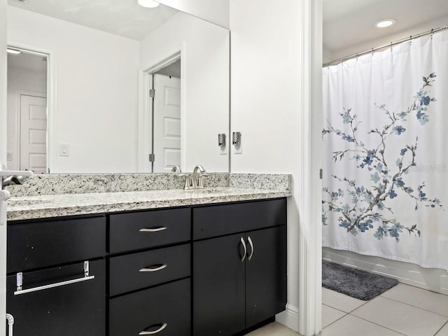 full bathroom with double vanity, a sink, shower / tub combo with curtain, and tile patterned floors