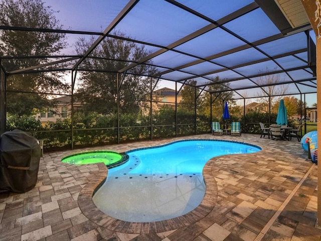 view of swimming pool featuring a patio, grilling area, a lanai, and a pool with connected hot tub