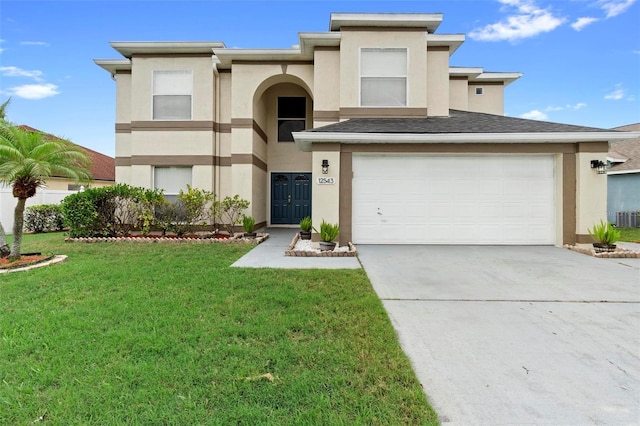 view of front of property with an attached garage, driveway, a front lawn, and stucco siding