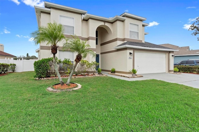 view of front of property with fence, a front lawn, concrete driveway, and stucco siding