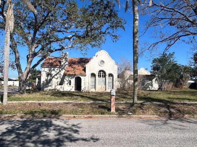 view of front of home with a tiled roof and stucco siding