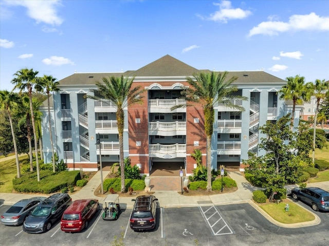 view of building exterior with uncovered parking