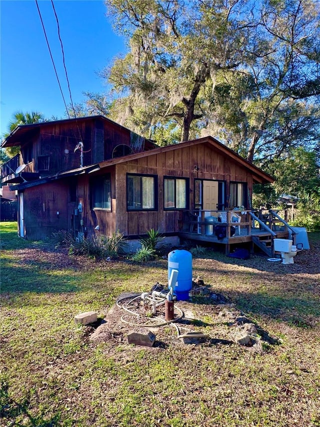 exterior space featuring a deck and a front yard