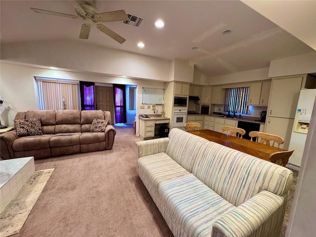 living room featuring light carpet, visible vents, lofted ceiling, ceiling fan, and recessed lighting