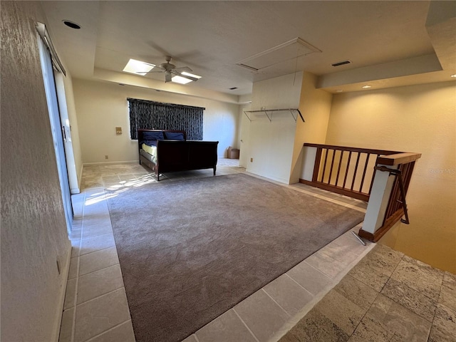 additional living space with ceiling fan, carpet floors, visible vents, baseboards, and attic access