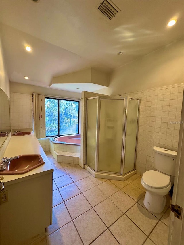 full bath featuring a garden tub, toilet, visible vents, vanity, and tile patterned floors