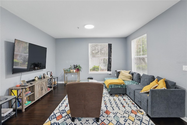 living room featuring dark wood finished floors and baseboards