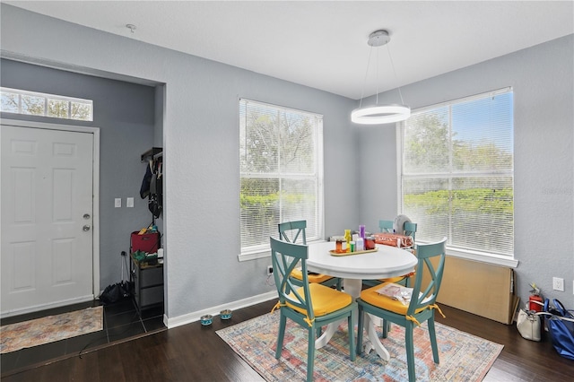 dining room featuring baseboards and wood finished floors