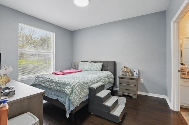 bedroom with baseboards and wood finished floors