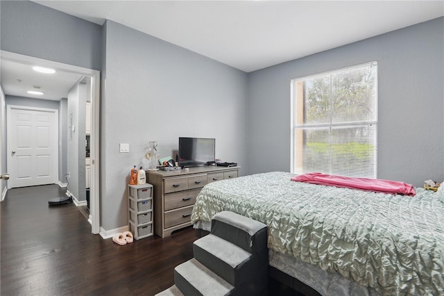 bedroom featuring dark wood-type flooring and baseboards