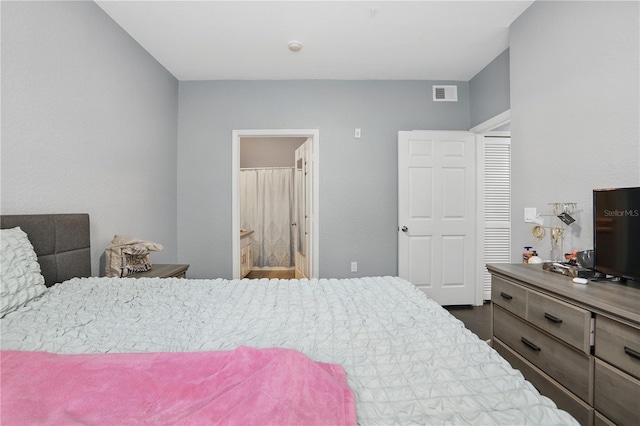 bedroom with visible vents and connected bathroom