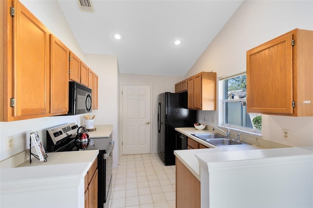 kitchen with visible vents, a sink, black appliances, vaulted ceiling, and light countertops