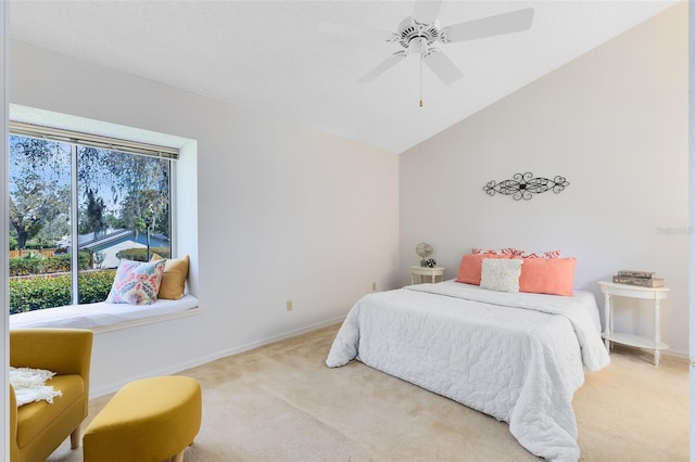 carpeted bedroom featuring vaulted ceiling, baseboards, and ceiling fan