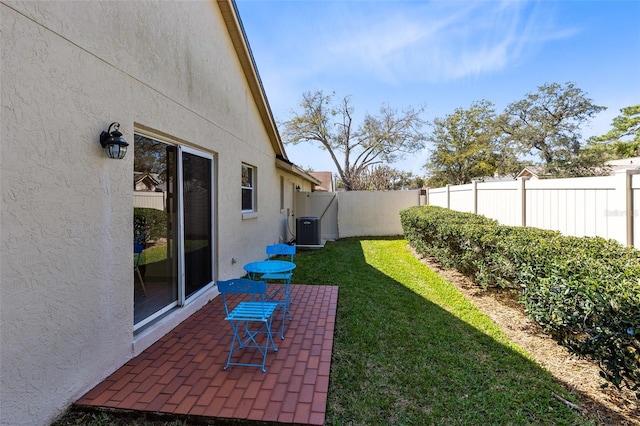 view of yard featuring a patio, cooling unit, and a fenced backyard