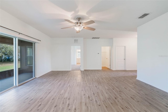 spare room featuring a ceiling fan, visible vents, light wood-style flooring, and baseboards