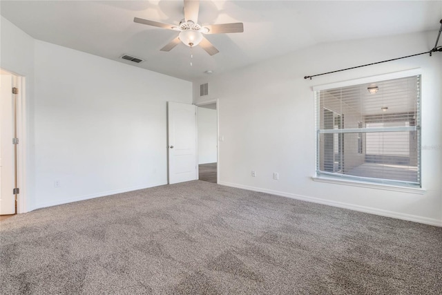 unfurnished room featuring carpet floors, vaulted ceiling, visible vents, and ceiling fan