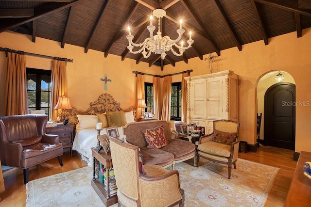 living room featuring wooden ceiling, arched walkways, light wood finished floors, and a notable chandelier