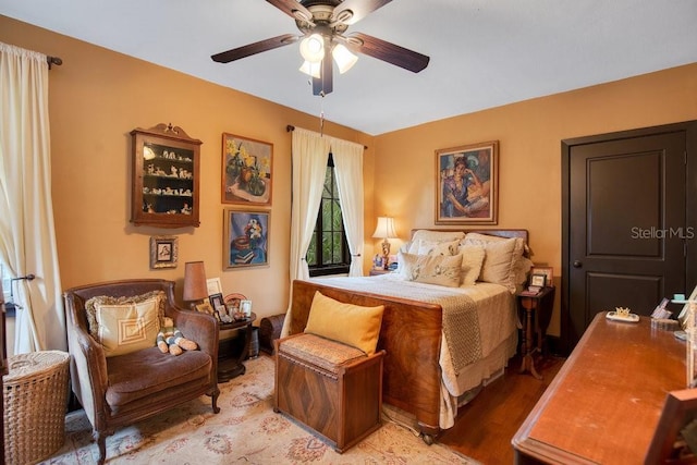 bedroom with light wood-style flooring and a ceiling fan