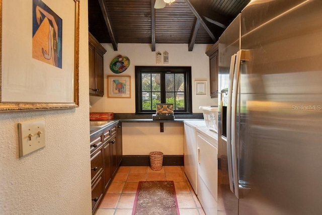 kitchen with washing machine and dryer, wood ceiling, stainless steel refrigerator with ice dispenser, beam ceiling, and dark countertops