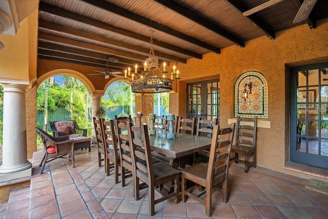 tiled dining area featuring beamed ceiling, plenty of natural light, and ornate columns