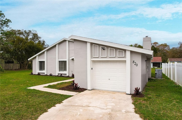 garage with driveway, fence, and central air condition unit