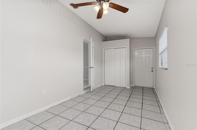 unfurnished bedroom featuring a ceiling fan, a closet, visible vents, and baseboards