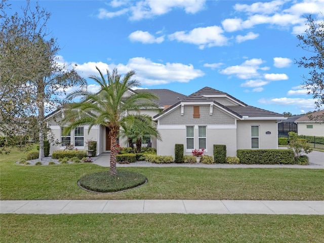 view of front facade featuring a front lawn and stucco siding