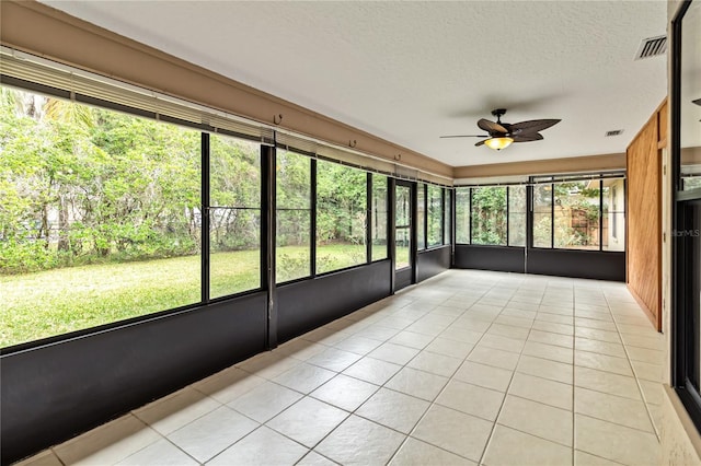 unfurnished sunroom featuring visible vents and a ceiling fan