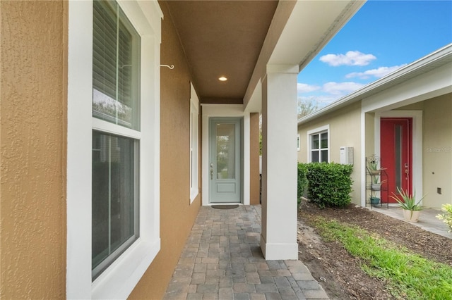 view of exterior entry with stucco siding