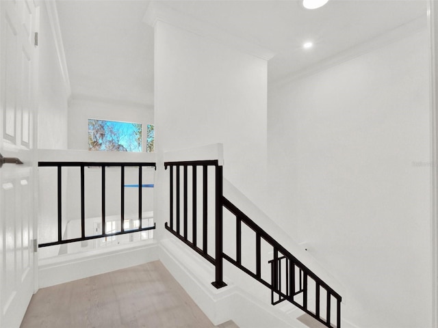 stairs featuring ornamental molding, recessed lighting, and a high ceiling