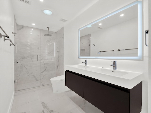 bathroom with toilet, marble finish floor, a sink, and a stall shower