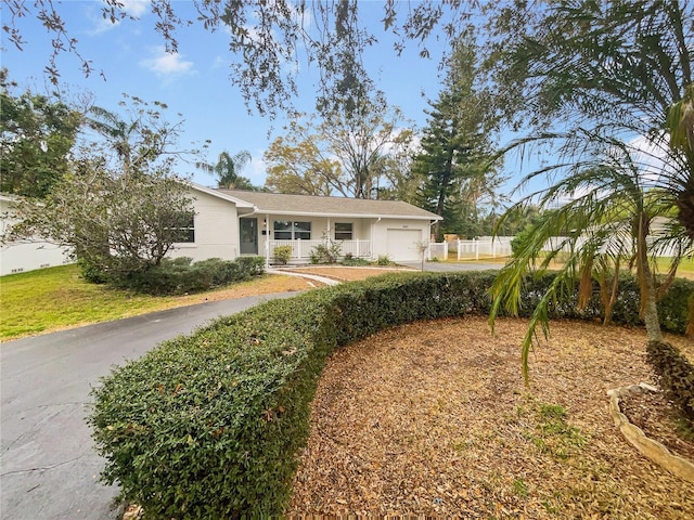 ranch-style house with an attached garage and driveway