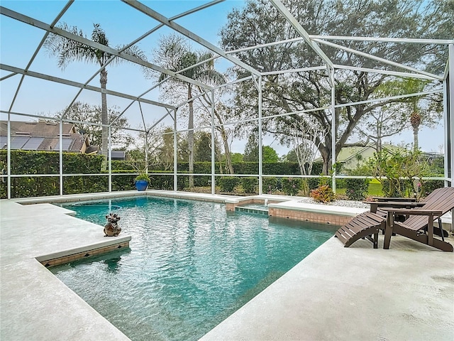 pool with a lanai and a patio area