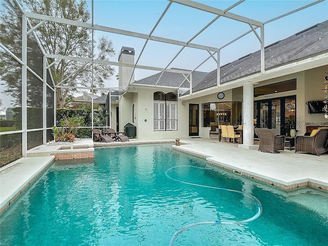 pool with a lanai and a patio