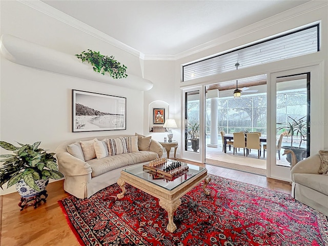 living room with ornamental molding and wood finished floors