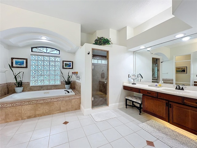 bathroom with a stall shower, a garden tub, vanity, and tile patterned floors