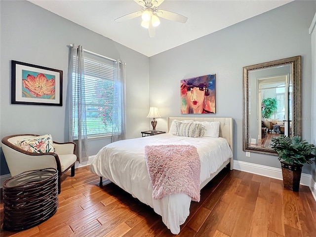 bedroom with a ceiling fan, baseboards, and hardwood / wood-style floors