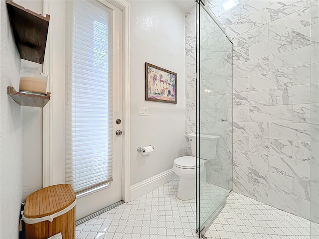 bathroom featuring toilet, baseboards, and a walk in shower