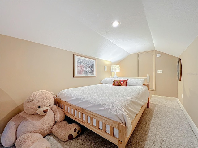 bedroom featuring baseboards, vaulted ceiling, a textured ceiling, and light colored carpet