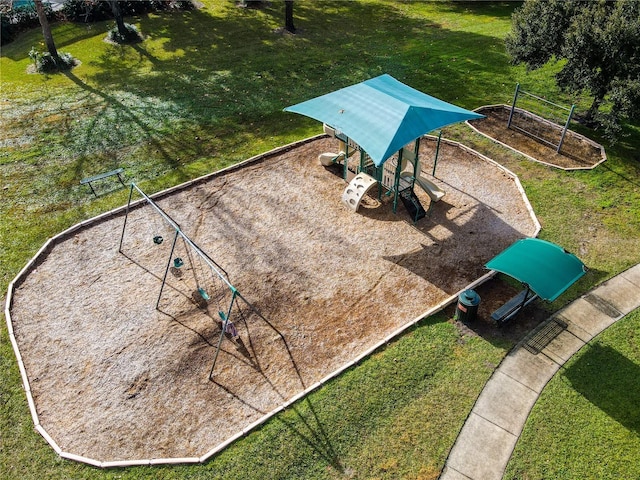 surrounding community featuring a playground and a lawn