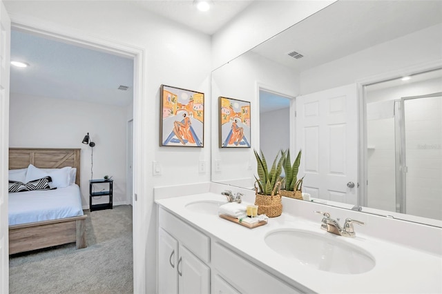 bathroom featuring double vanity, a sink, visible vents, and connected bathroom