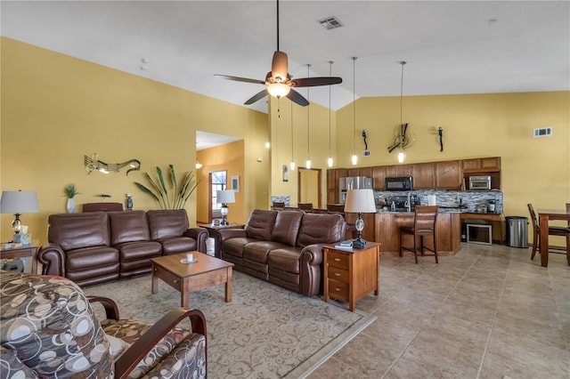 2825 Lake Tohopekaliga Blvd, Kissimmee, FL 34746 - living area with vaulted ceiling, visible vents, ceiling fan, and light tile patterned floors