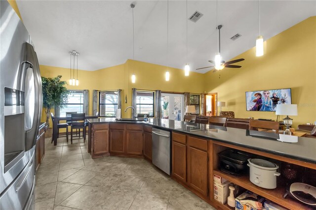 2825 Lake Tohopekaliga Blvd, Kissimmee, FL 34746 - kitchen featuring dark countertops, brown cabinetry, appliances with stainless steel finishes, and a sink