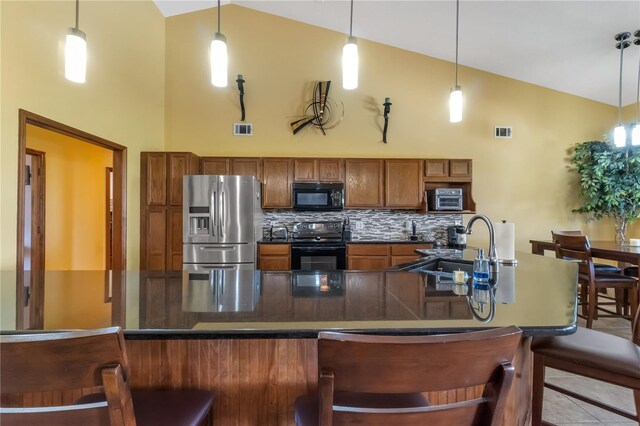 2825 Lake Tohopekaliga Blvd, Kissimmee, FL 34746 - kitchen featuring dark countertops, high vaulted ceiling, a sink, and black appliances